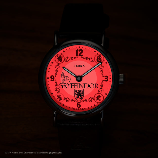Harry Potter x Timex Weekender Gryffindor House watch illuminated in red INDIGLO night-light mode.