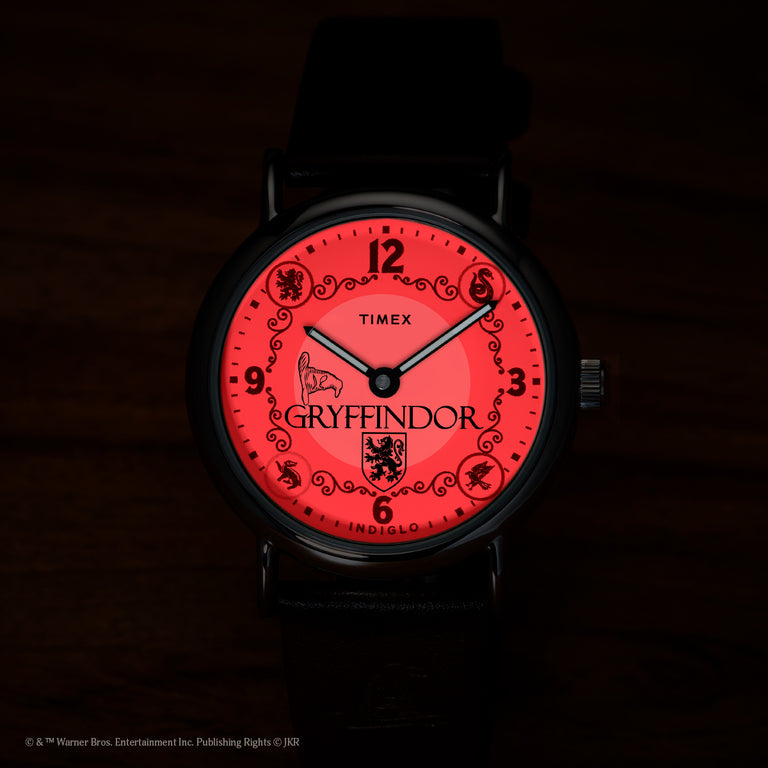 Harry Potter x Timex Weekender Gryffindor House watch illuminated in red INDIGLO night-light mode.