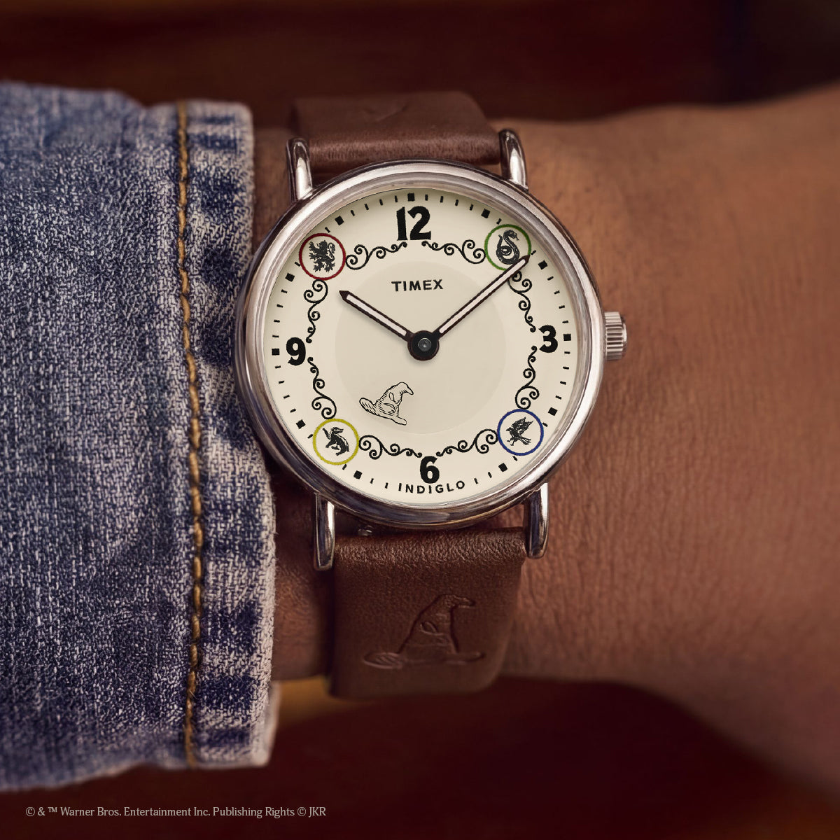 Harry Potter x Timex Weekender Ravenclaw watch worn on wrist featuring house icons and Sorting Hat detail.