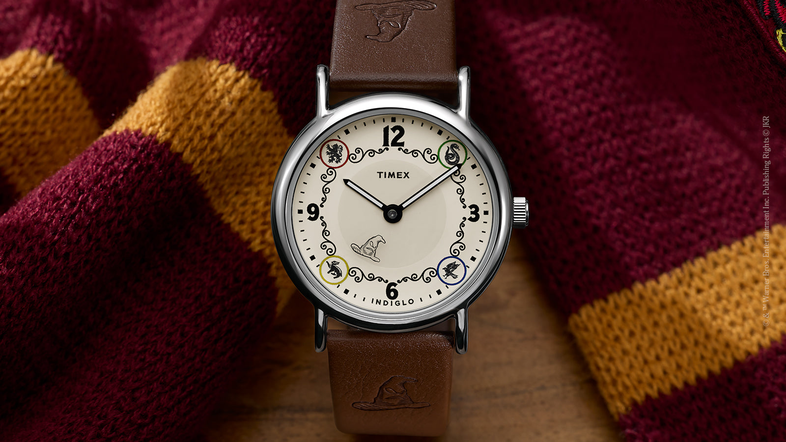 Front view of Harry Potter x Timex Weekender Gryffindor House watch with silver-tone case and brown leather strap.