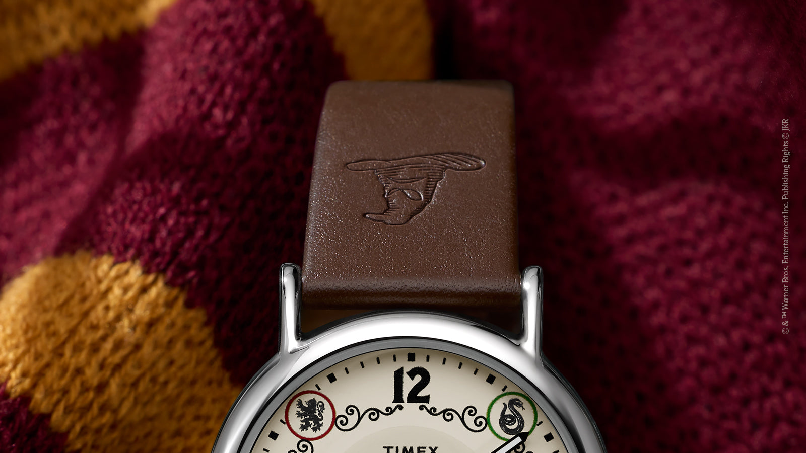 Close-up of brown leather strap embossed with Sorting Hat on Harry Potter x Timex Gryffindor watch.