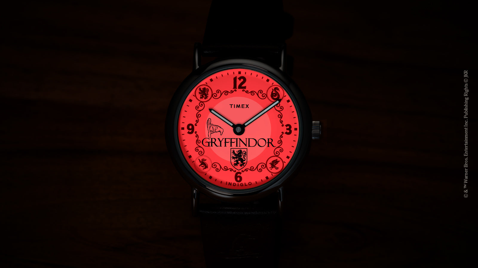 Harry Potter x Timex Weekender Gryffindor House watch illuminated in red INDIGLO night-light mode.