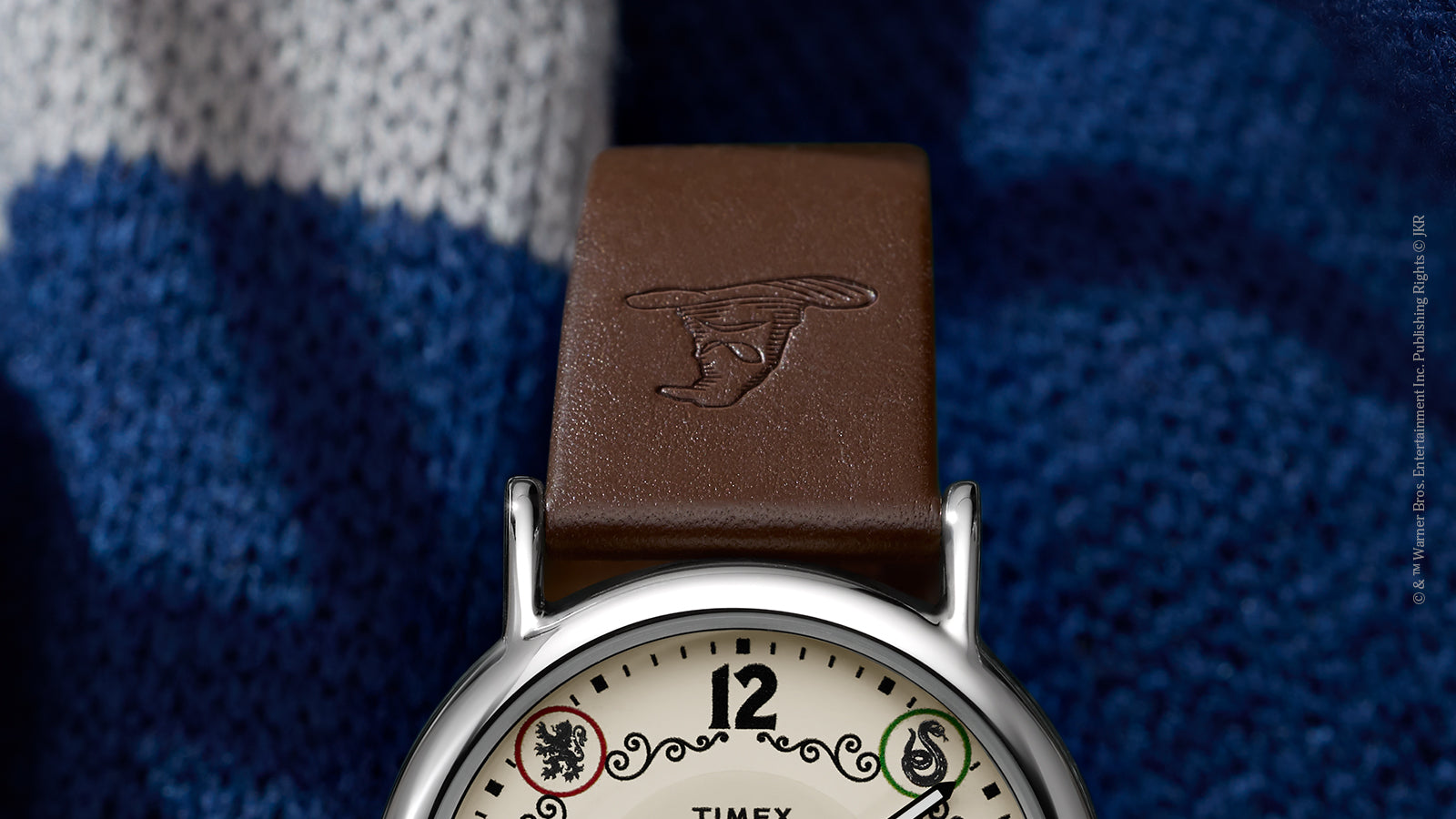 Close-up of brown leather strap embossed with Sorting Hat on Harry Potter x Timex Ravenclaw watch.
