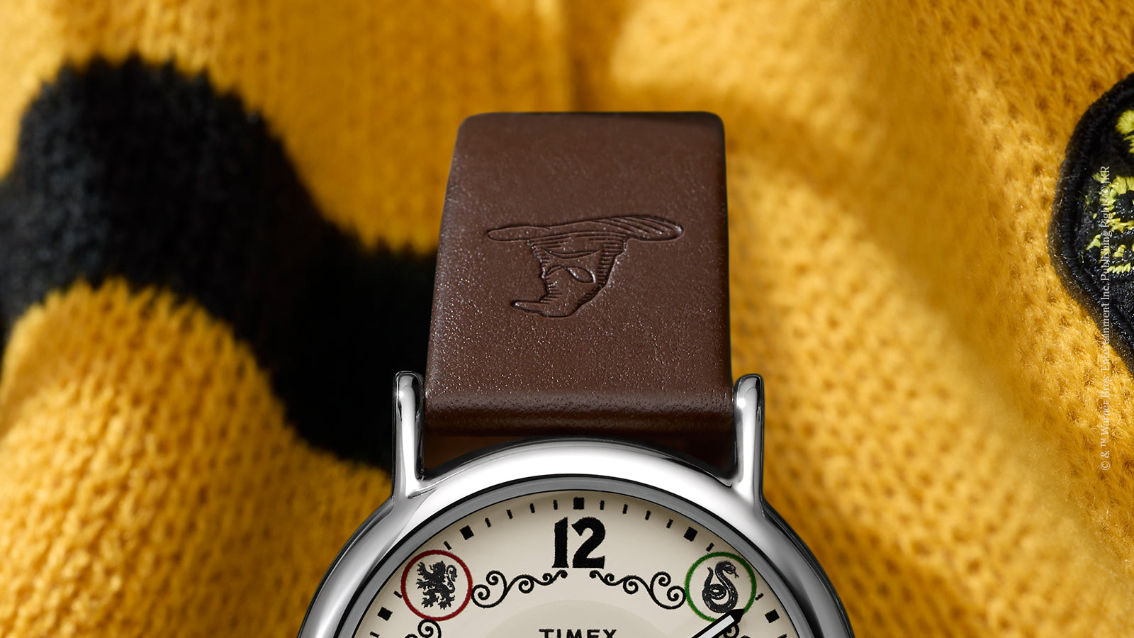 Close-up of brown leather strap embossed with Sorting Hat on Harry Potter x Timex Hufflepuff watch.