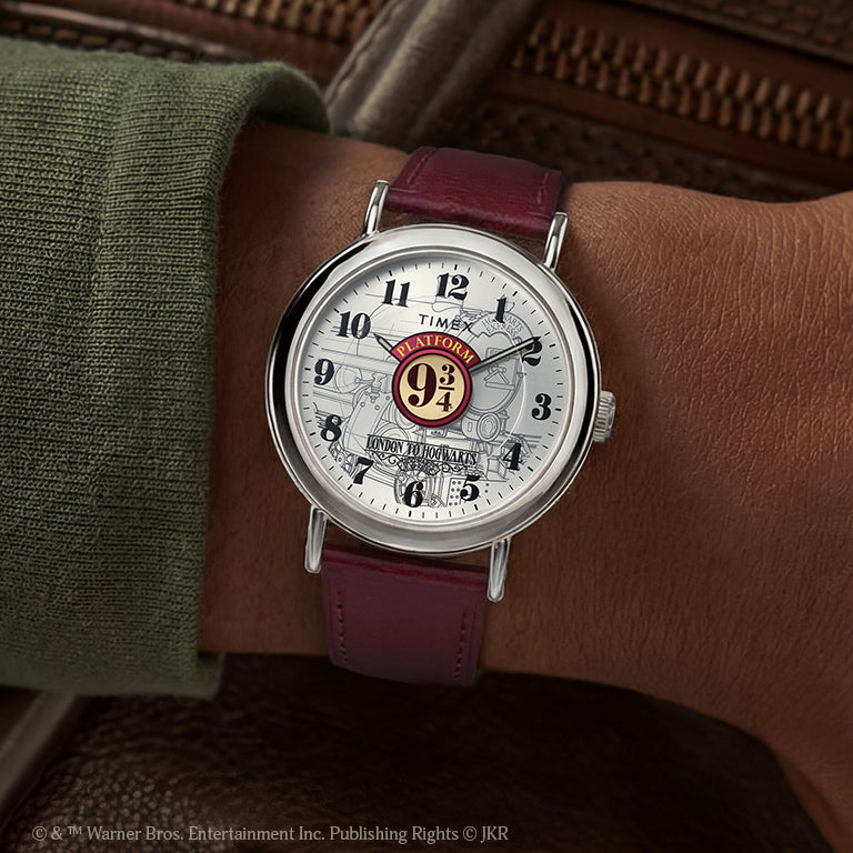 Close-up of a Timex x Harry Potter Weekender watch with a burgundy leather strap and Platform 9¾ design on the dial, worn on wrist.