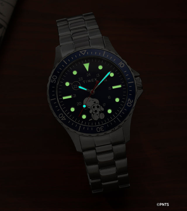 Timex Navi Snoopy soccer watch glowing in the dark with luminous markers and hands on blue dial
