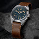 Timex Expedition Capstone watch with blue dial and brown leather strap on rock surface