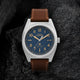 Close-up of Timex Expedition Capstone watch with blue dial, Arabic numerals, and leather strap