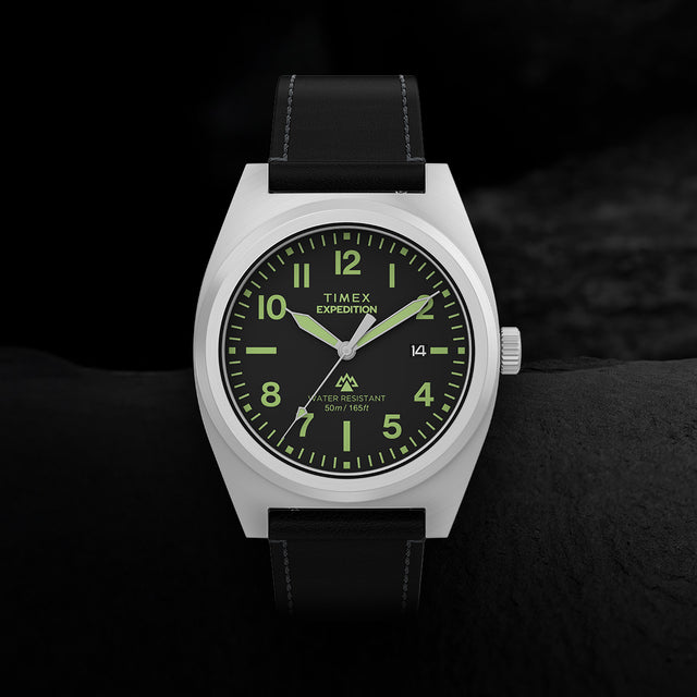 Close-up of Timex Expedition Capstone watch with black dial, Arabic numerals, and leather strap