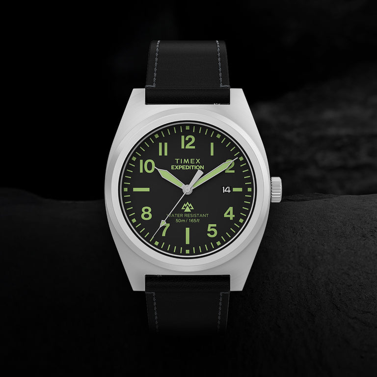 Close-up of Timex Expedition Capstone watch with black dial, Arabic numerals, and leather strap