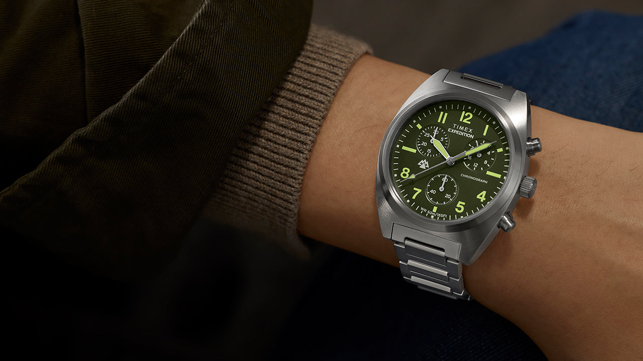 Timex Expedition Capstone Chronograph watch on wrist with green dial and stainless steel bracelet