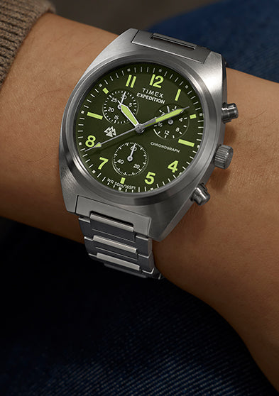 Timex Expedition Capstone Chronograph watch on wrist with green dial and stainless steel bracelet