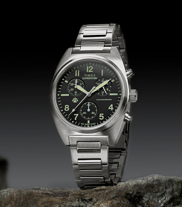 Timex Expedition Capstone Chronograph with stainless steel bracelet displayed on rocks outdoors