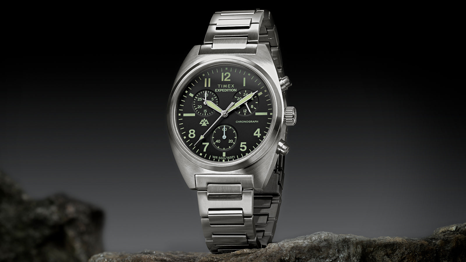 Timex Expedition Capstone Chronograph stainless steel watch with black dial on rock surface