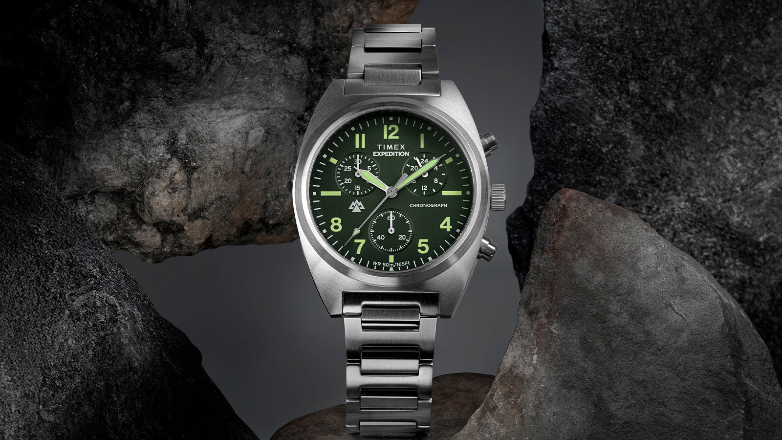 Timex Expedition Capstone Chronograph stainless steel watch with green dial on rock surface