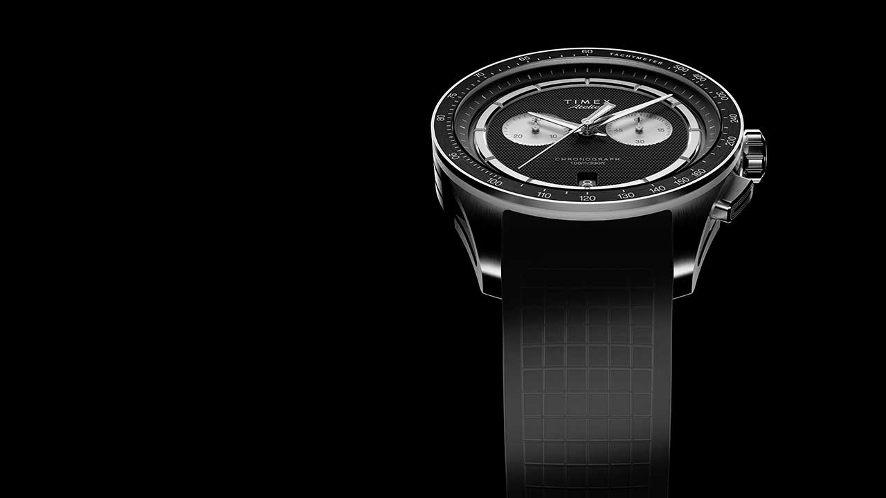 Top view of Timex Atelier Chronograph Quartz M1a 40mm with black textured dial and NBR rubber strap on black background