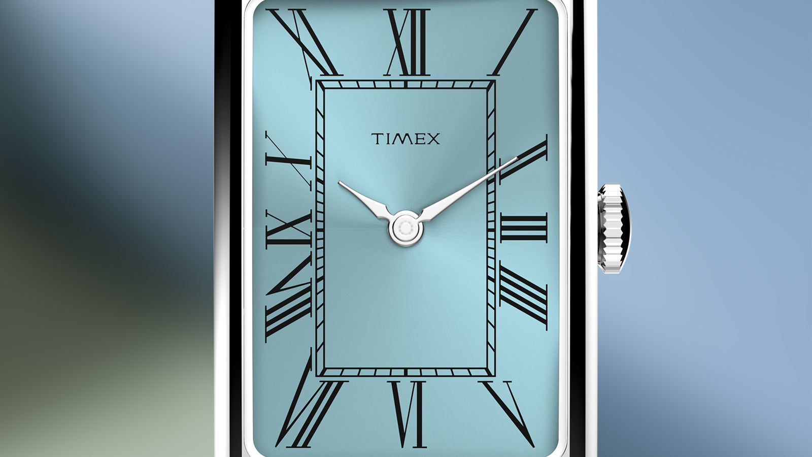 Close-up of the Timex® 1976 Lexington Reissue Inspired dial featuring a light blue sunray finish, Roman numeral hour markers, and silver-tone hands.