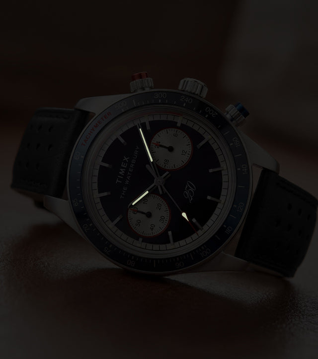 Waterbury Heritage America 250 Chronograph watch showcasing luminous hands and markers in low-light conditions.