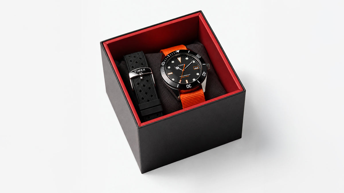 Bespoke Post x Timex Heritage 66 watch presented in a black and red box with orange and black straps.