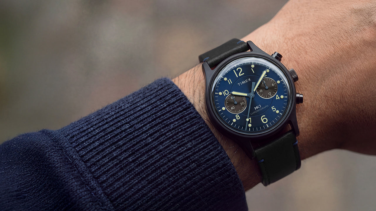 Close-up of the Timex MK1® Chronograph with a blue dial and black leather strap worn on the wrist.