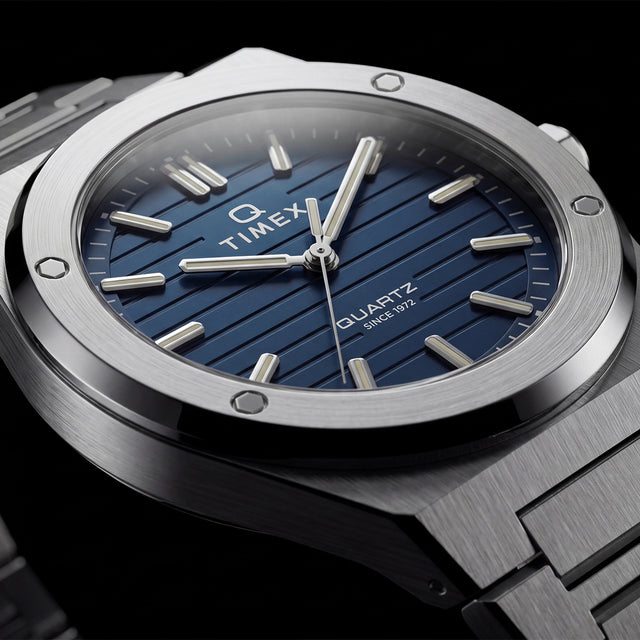 Close-up of the Timex Q Marbella blue textured dial with a brushed stainless steel bezel and integrated bracelet.