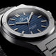 Close-up of the Timex Q Marbella blue textured dial with a brushed stainless steel bezel and integrated bracelet.