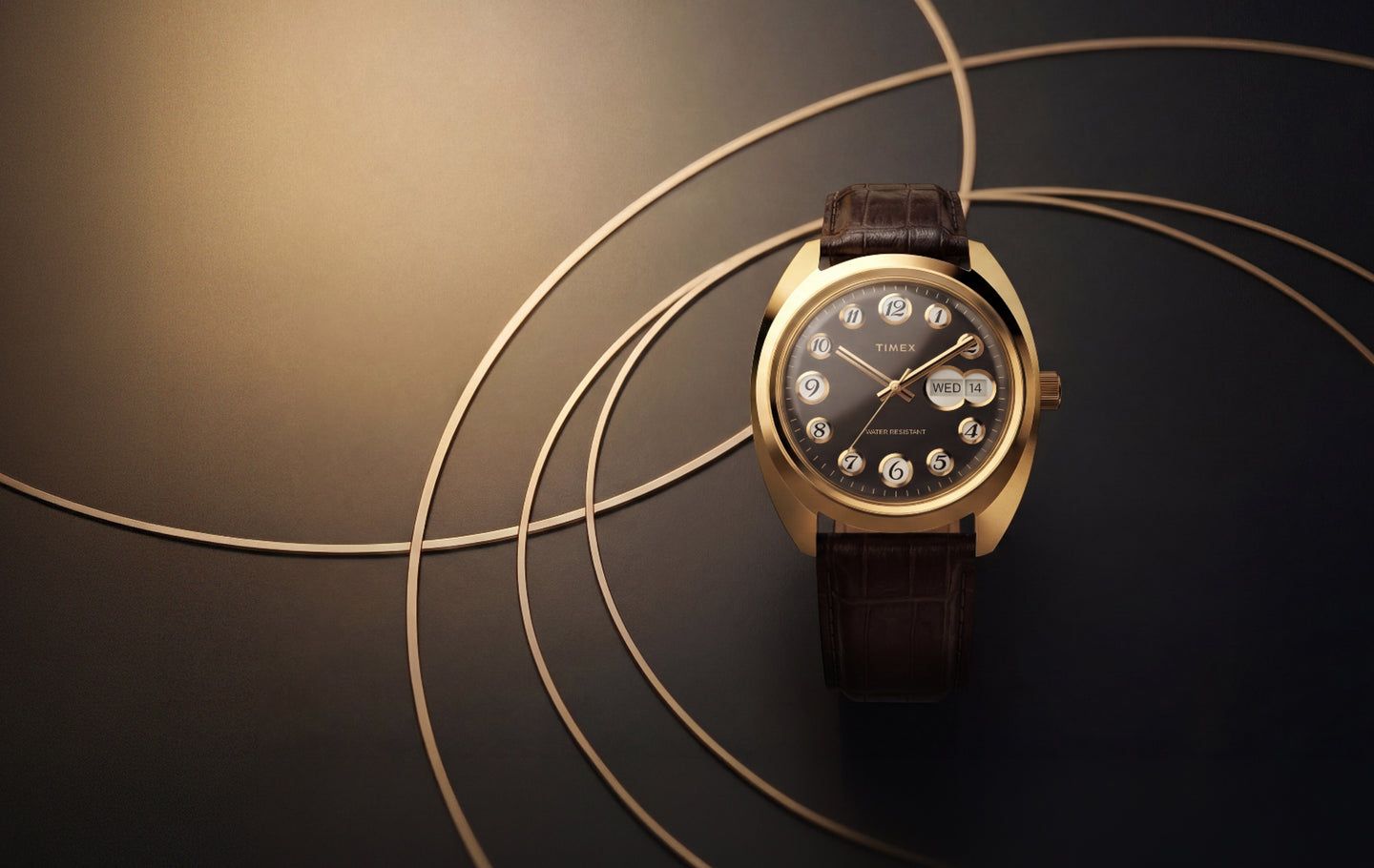 Timex® 1976 Rotary Phone Dial Reissue watch with a gold-tone case, black dial and brown leather strap surrounded by curved gold lines.