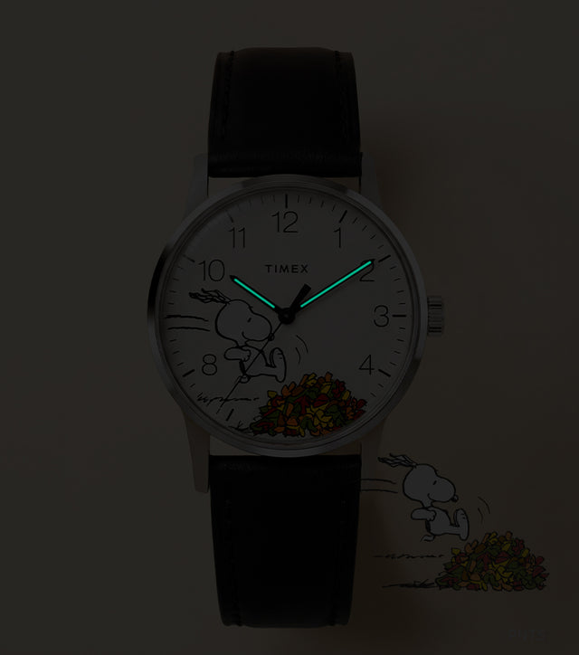 Peanuts® x Timex Waterbury Classic watch with INDIGLO® illumination highlighting the glowing hour and minute hands.