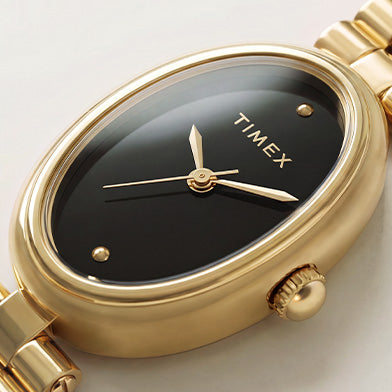 Close-up of the Timex Cavatina® Luxe black dial with gold-tone hands and polished gold-tone oval case.