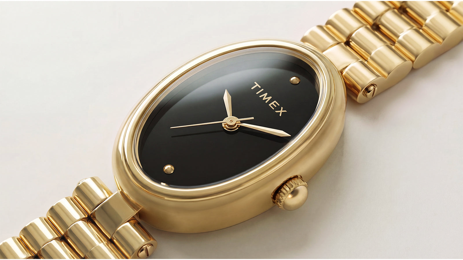 Close-up of the Timex Cavatina® Luxe featuring a polished gold-tone oval case, glossy black dial, and minimalist gold-tone hands.