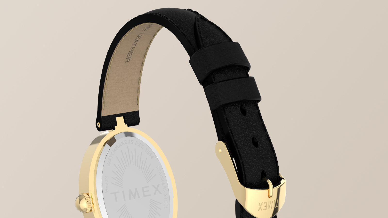 Primer plano de la correa de piel negra del Timex Cavatina® Luxe, con una hebilla dorada y un fondo de caja dorado pulido.