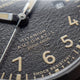 Close-up of the Expedition® Field Post Automatic textured black dial showing automatic movement, 200m water resistance, and shock resistance.