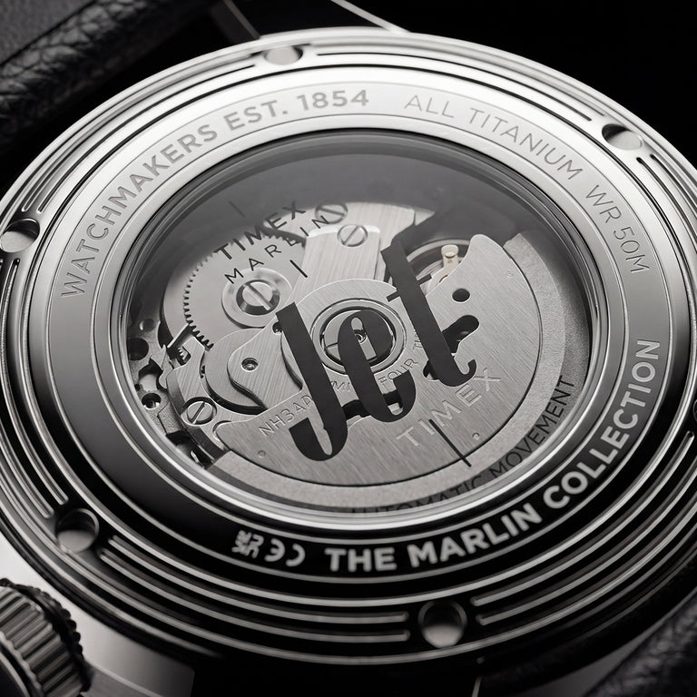 Exhibition caseback of the Timex Marlin® Jet Titanium Automatic GMT showing the automatic movement and custom Timex rotor through a transparent crystal caseback.