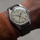 Timex Marlin® Jet Titanium Automatic GMT worn on wrist, featuring a lightweight titanium case, cream dial, red GMT hand, and black leather strap.