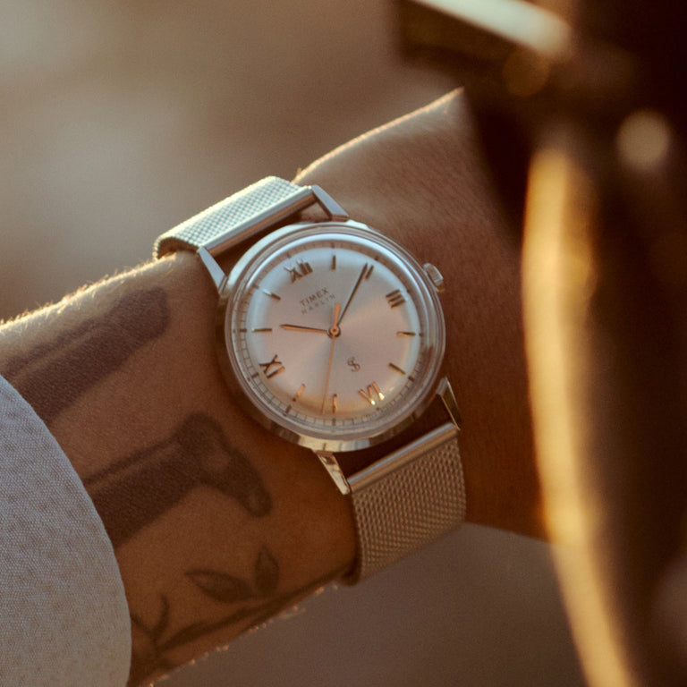 Close-up of the Todd Snyder x Timex Marlin® Mesh watch with a silver sunray dial and stainless steel mesh bracelet worn on the wrist.