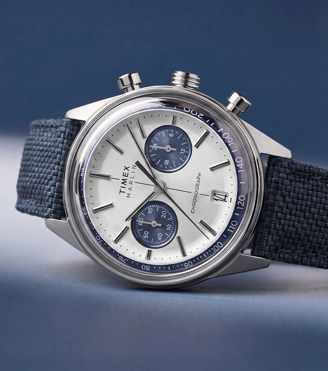 Timex Marlin® Jet Chronograph with a silver-tone dial, blue subdials, and blue fabric strap.