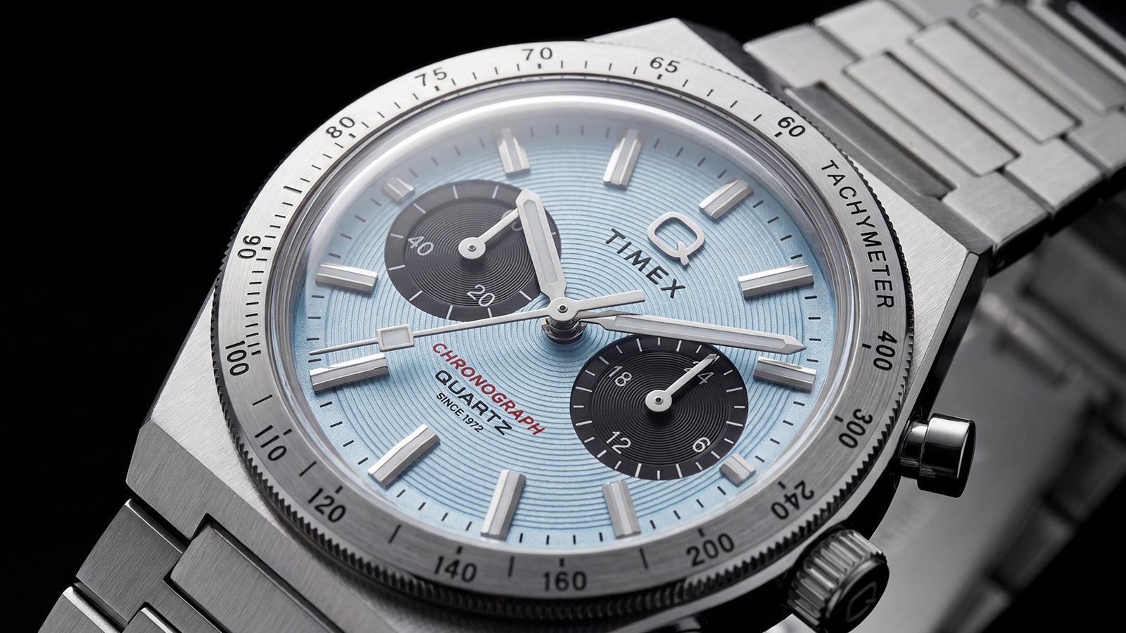 Close-up of the Q Timex Continental Chronograph featuring an ice blue textured dial, black subdials, and stainless-steel tachymeter bezel.