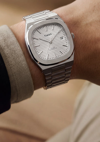 Timex Automatic E Line 38mm with a silver-tone dial and stainless-steel bracelet, shown on the wrist.