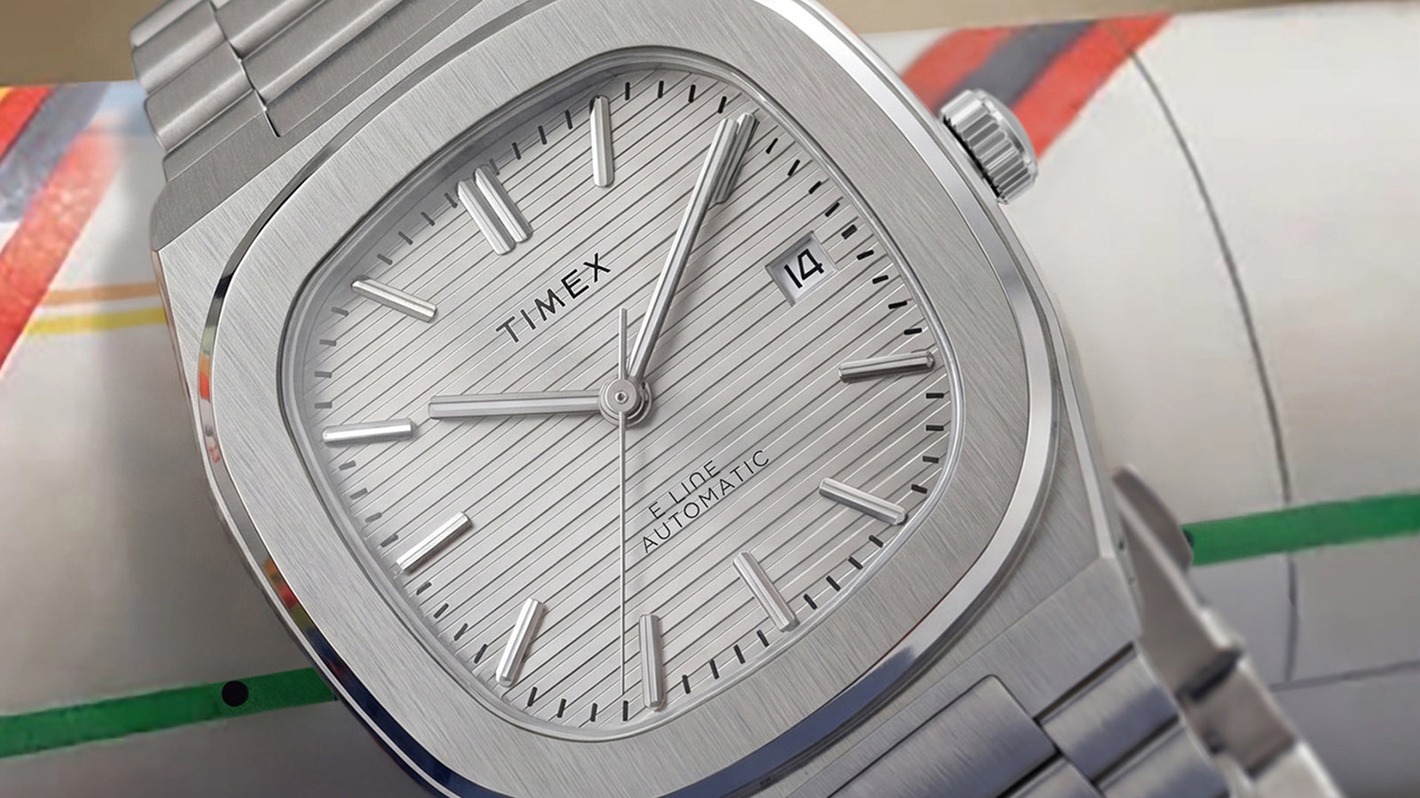 Close-up of the Timex Automatic E Line 38mm, highlighting its textured silver-tone dial, applied hour markers, and date window.