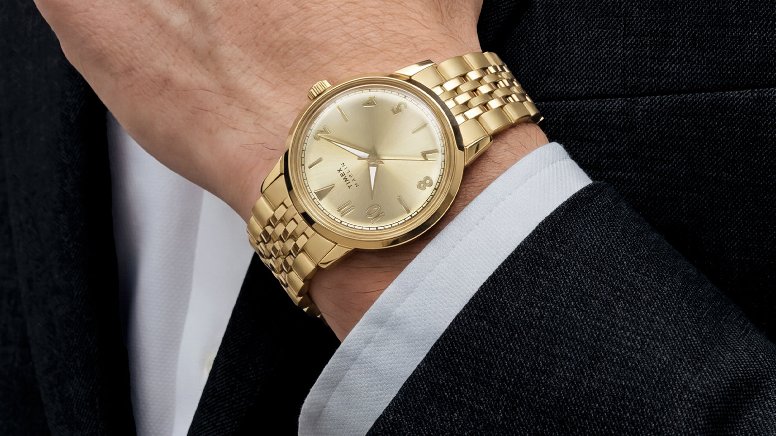 Close-up of the Timex Marlin Quartz with a champagne sunray dial and gold-tone stainless steel bracelet worn on the wrist.