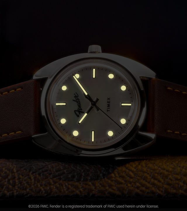Fender x Timex watch displayed in low light with glowing hands and hour markers.