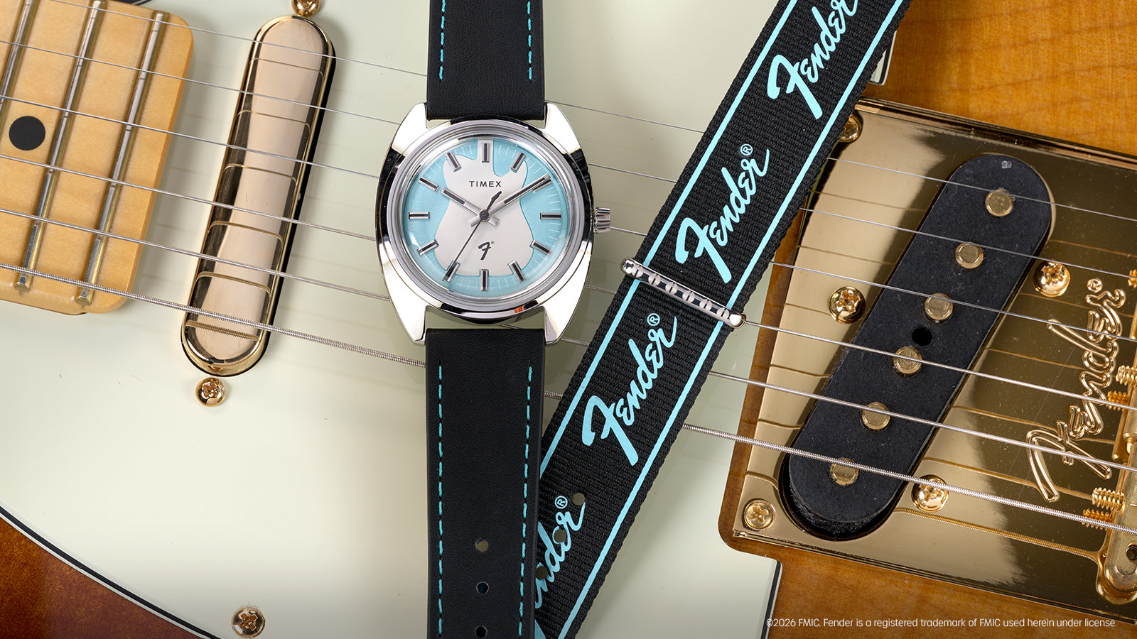 Fender x Timex watch with a silver-tone case and black strap displayed across a Fender electric guitar.