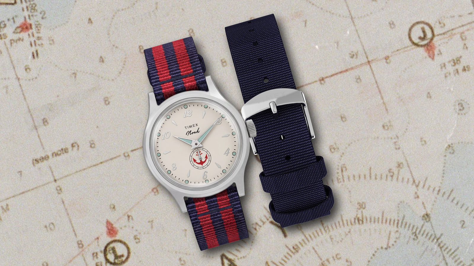 Reloj NOAH x Timex MK1 Anchor con correa de tela a rayas y una correa adicional de color azul marino, expuesto sobre una carta náutica.