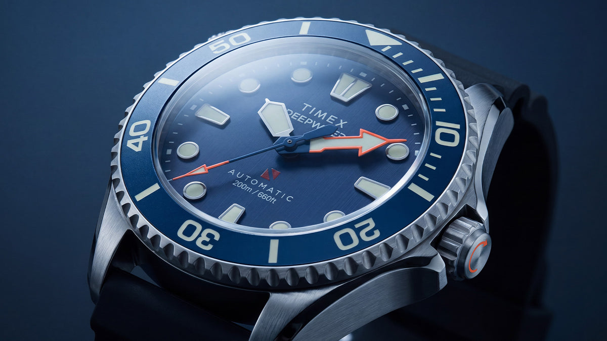 Angled close-up of the Deepwater Meridian 200 HEV Automatic’s blue dial, luminous markers, red arrow hands, and blue dive bezel.