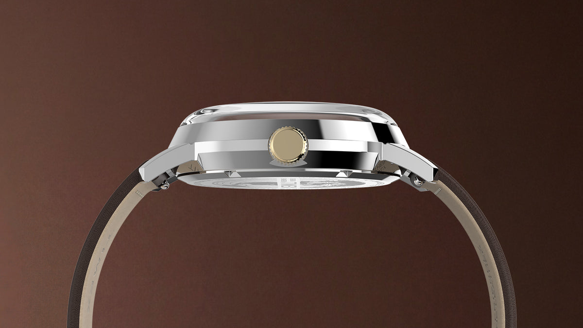 Side profile of the Marlin® Quartz GMT highlighting its polished case, gold-tone crown, domed crystal, and brown leather strap.