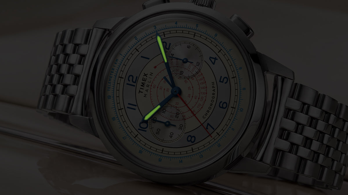 Close-up of the Marlin® Neo Classic Chronograph in low light with green luminous hour and minute hands.