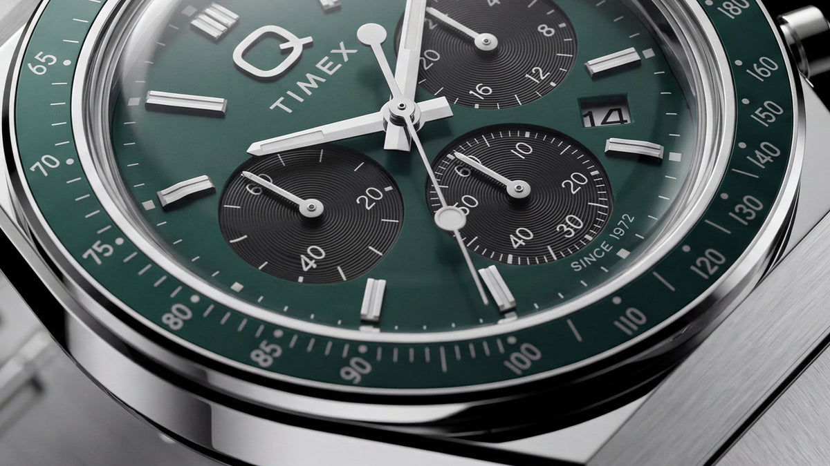 Close-up of the Q Timex Chronograph’s green dial, black subdials, date window, and tachymeter bezel.