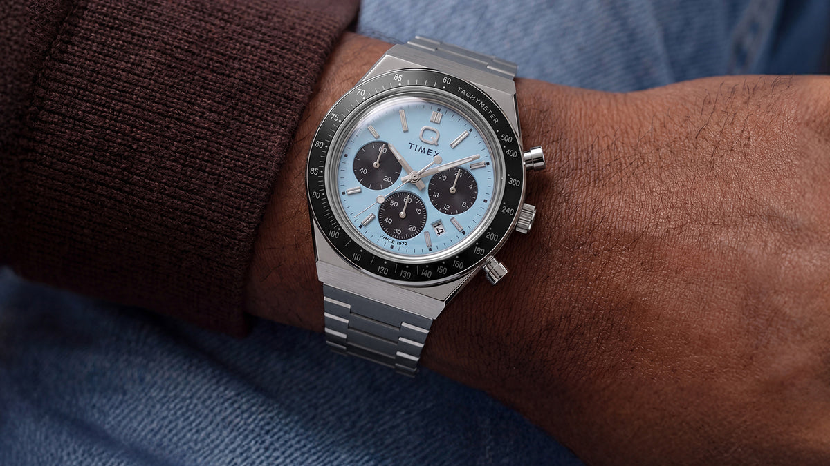 Q Timex Chronograph with an ice-blue dial and stainless-steel bracelet styled on the wrist.