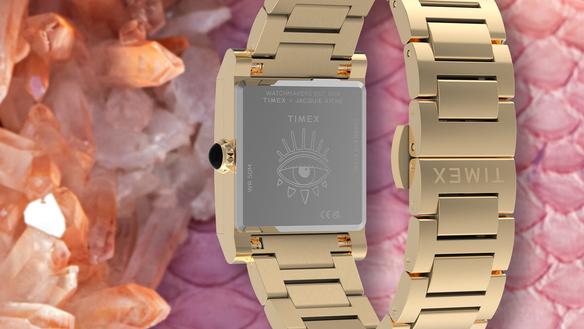 Rear view of the gold-tone Éclat watch showing its engraved eye motif and stainless-steel bracelet.