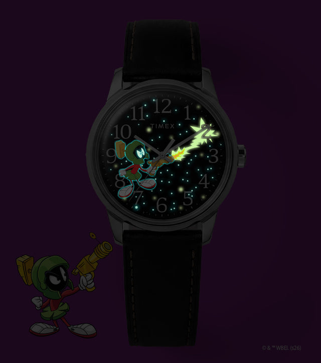 TW2Y99300 Marvin the Martian x Timex Easy Reader® watch with glowing stars, character details, and a ray-gun blast beside Marvin artwork.